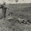 Soldier With Gun By a Soldier's Corpse